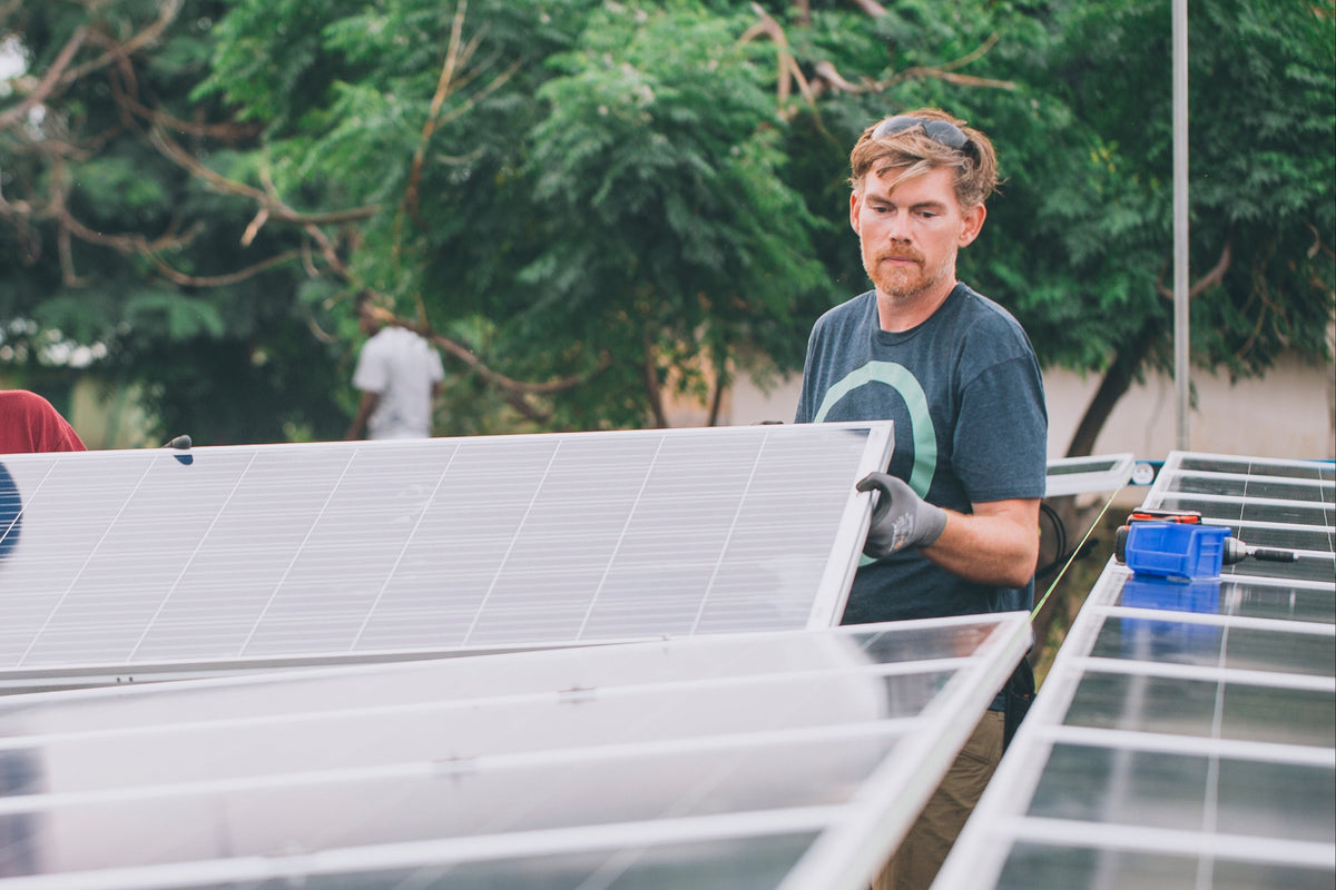 Joe O'Connor installing solar panels in an outdoor setting